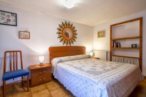 a bedroom with a bed and a chair and a mirror at Casetta Brandinu in Sassari