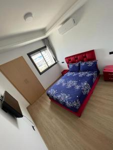 a bedroom with a bed and a flat screen tv at Étoile Harhoura in El Harhoura +14 photos
