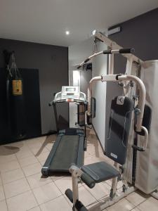 a gym with a treadmill and a chair in a room at LuxHoliday Apartment in Carpignano Salentino