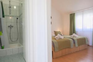 a bedroom with a bed and a shower and a tub at Aurora Apartments in Bol +100 photos