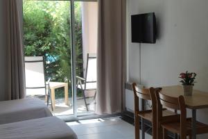 a bedroom with a bed and a table and a window at Les Canyons du Verdon in Castellane