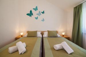 a bedroom with two beds with towels on them at Aurora Apartments in Bol