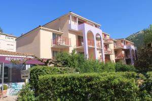 a large building with bushes in front of it at Les Canyons du Verdon in Castellane