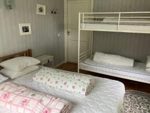 two bunk beds in a room with two beds at Karaby Gård, Country Living in Kristinehamn
