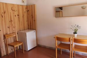 a small kitchen with a table and a refrigerator at Les Canyons du Verdon in Castellane