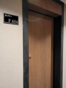 a brown door with a sign on a wall at Apartament Bel Mare F 604 in Międzyzdroje +31 photos
