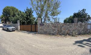 a car parked next to a stone wall at Tiny Datca in Datca