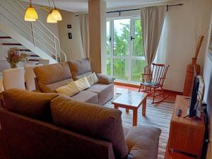 sala de estar con sofá y TV en Apartamento Turístico Merón, Duplex (1 llave), en San Vicente de la Barquera