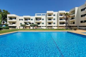 a large swimming pool in front of a building at Sea Beside in Albufeira