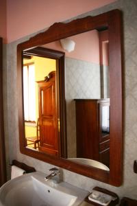 a mirror above a sink in a bathroom at Agriturismo Cascina la Palazzina in Albairate +70 photos