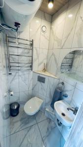 a white bathroom with a sink and a toilet at Saulėlydis in Dreverna +42 photos