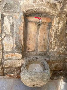a stone bathroom with a stone toilet in a stone wall at Mainotti's house in Areopolis