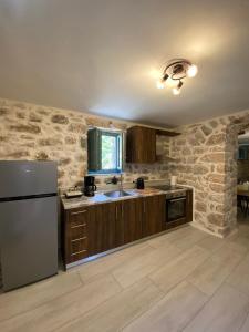 a kitchen with a refrigerator and a sink at Mainotti's house in Areopolis