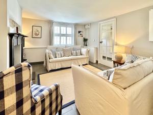 a living room with two couches and a fireplace at Laurel Cottage Sandsend in Sandsend