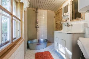 a bathroom with a tub and a sink at Nurme farm 