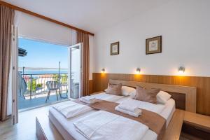 Posteľ alebo postele v izbe v ubytovaní Hotel Vicko