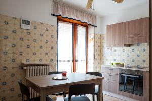 a kitchen with a table and chairs in a kitchen at Casa vacanza Semia in Vinadio