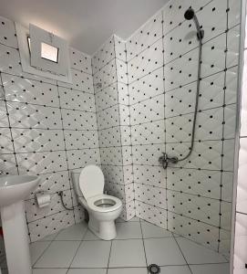a bathroom with a toilet and a sink at Joni Apartments in Ksamil