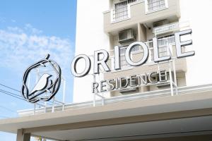 a sign for a hotel on top of a building at Oriole Residence - Suvarnabhumi in Ban Khlong Thewa