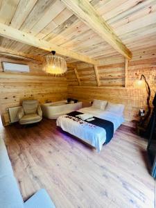 a bedroom with a bed and a tub in a room at Elegant Bungalov in Rize +14 photos
