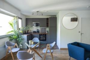 a living room with a glass table and chairs at MYAPPARTBORDEAUX in Bordeaux