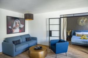a living room with a blue couch and a blue chair at MYAPPARTBORDEAUX in Bordeaux +10 photos
