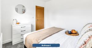 a white bedroom with a bed and a dresser at Dudley - Stylish 3 Bedroom Sleeps 6 Wi-Fi - JRR Stays in Woodside