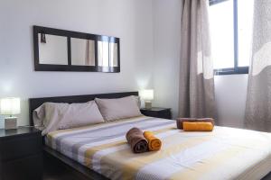 une chambre avec un lit avec deux serviettes dessus dans l'établissement Piso Dunas Blu - Carpe Mundi, à Corralejo 15 autres photos