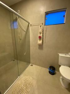 a bathroom with a shower and a toilet at CHALÉS VALE DO LAGO in Capitólio