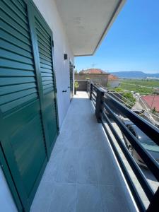 a balcony with a green door and a view at Primus Štrbić in Ploče