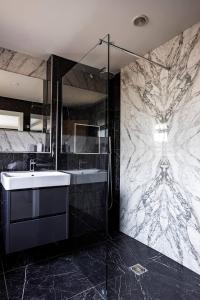 a bathroom with a sink and a shower and a tub at Kingsley Paddocks in Chew Stoke