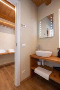 a bathroom with a sink and a mirror at Bed & Bike La Stalla in Masera