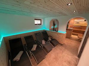 a group of chairs in a bar in a room at Hotel Pension Siggi in Sankt Leonhard im Pitztal