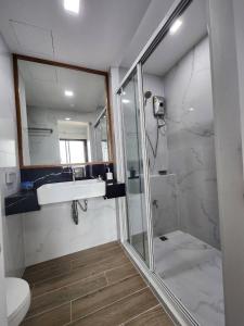 a bathroom with a shower and a sink and a toilet at ABoutNont HOTEL & MANSION in Nonthaburi