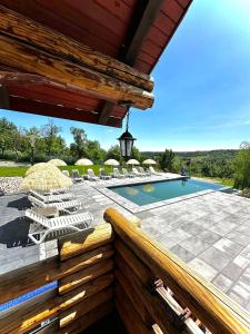 a patio with lounge chairs and a swimming pool at Agropensiunea Colev in Stremţ