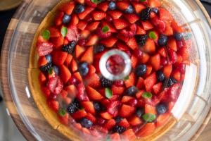 a fruit pie with strawberries and blueberries in a bowl at Les Regalia Hôtel & Spa in Sainte-Lucie de Porto-Vecchio