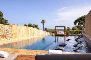 a swimming pool with dolphins in the water at Les Regalia Hôtel & Spa in Sainte-Lucie de Porto-Vecchio