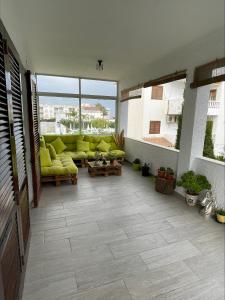 a large living room with yellow couches on a building at Edificio Guadalupe in Alcossebre