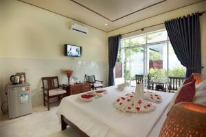 a living room with a table with food on it at Sunlight Bungalow in Phu Quoc