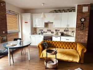 a living room with a couch and a table at Apartament Awiator Gdańsk in Gdańsk
