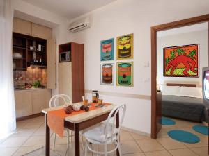 a kitchen and dining room with a table and chairs at Vibrant Apartment in Rimini with Balcony in Rimini