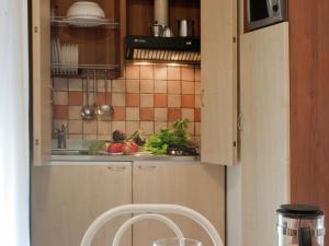 a kitchen with a sink and fruits and vegetables at Vibrant Apartment in Rimini with Balcony in Rimini