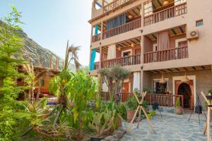 a building with a lot of plants in front of it at Smile House Imlil in Imlil