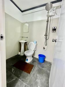 a bathroom with a toilet and a shower at Transient Home at Tierra Vista near SM Dasma with Wifi and Netflix in Mabatang