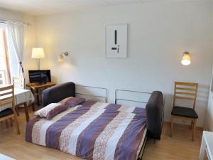 a bedroom with a bed and a table and chairs at Apartment Farinet B 21 by Interhome in Crans-Montana