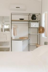 a kitchen with white walls and a white counter top at Pousada Seis e Meia in Trancoso