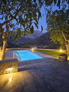 a swimming pool in a yard with a tree at Patriko-Cozy villa on the foot of the mountains in Ammoudari