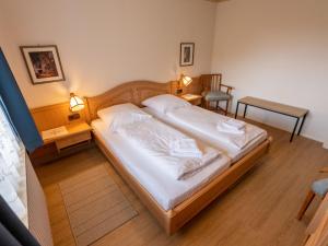 a bedroom with a large bed with white sheets at Holiday Home Sonnenbühl by Interhome in Dittishausen +54 photos