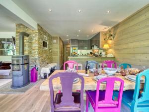 a dining room with a table and pink chairs at Apartment Apollo-4 by Interhome in Le Corbier