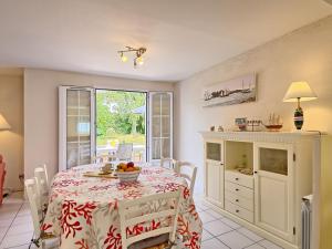 a dining room with a table with a bowl of fruit on it at Holiday Home Ar Mimoza - LBO301 by Interhome in Le Bono